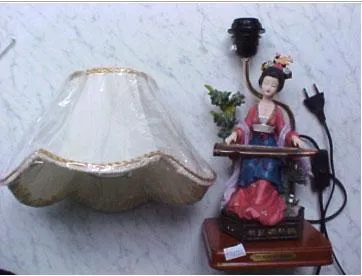 Table lamp illustrating a woman playing an instrument