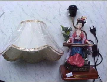 Table lamp illustrating a woman playing an instrument