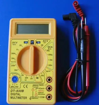 Digital multimeter in yellow/orange with test leads