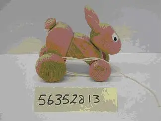 Игрушка-каталка - деревянный заяц на колёсах.