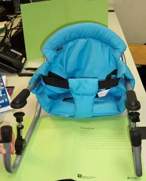 Blue table seat built on a metal structure which is fastened to the table top