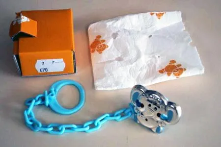 Pacifier holder with a brooch covered by a silver elephant