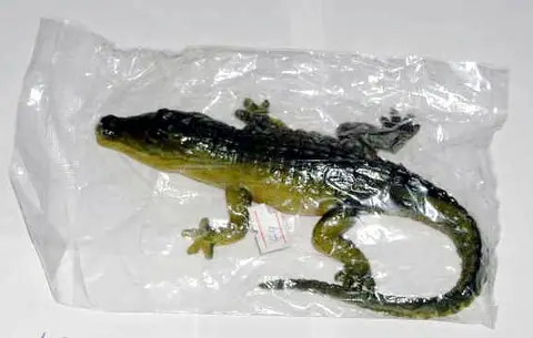 Green and yellow-brown toy sand filled crocodile