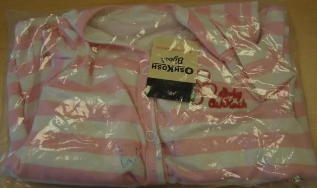 Babies' pyjamas with snap fasteners and a sewn on label indicating the importer